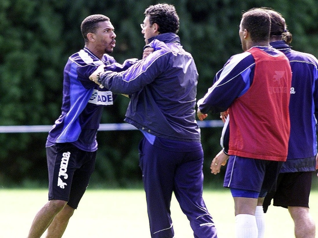 Momento tenso: Djalminha e o treinador discutem durante um treino. Os corpos inclinados e os rostos exaltados mostram o auge da toxicidade na relação treinador-atleta, onde o respeito é substituído pelo desgaste emocional.